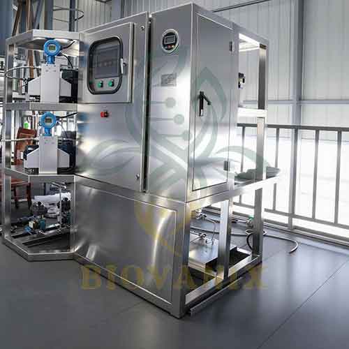 Stainless steel automated processing machine with control panel in a factory setting.